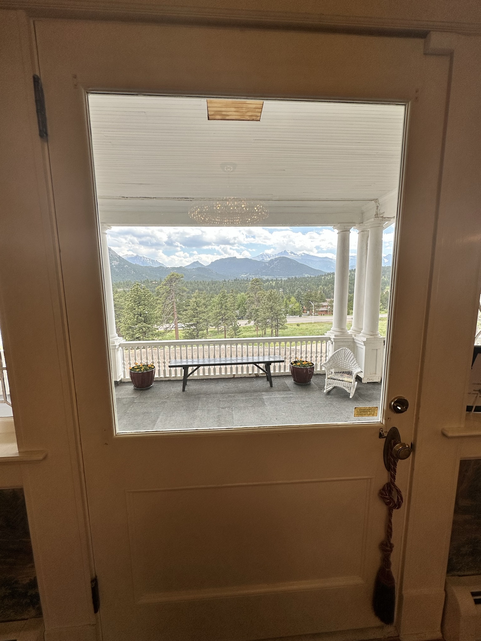 looking out the front door at the mesmerizing views of the rockies and longs peak at the stanley home museum in estes park